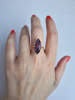 Bright marquise-cut amethyst in detailed setting