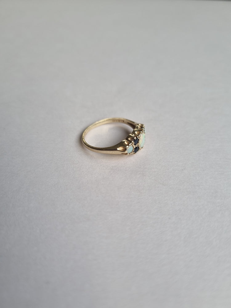 Opal boat ring inter spaced by tiny sapphire