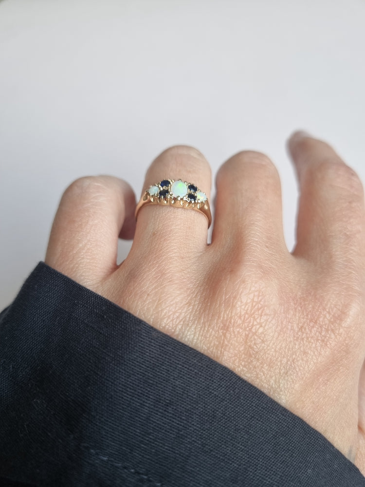Opal boat ring inter spaced by tiny sapphire
