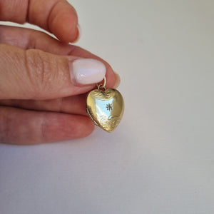 Gold heart locket, engraved and set with a round diamond