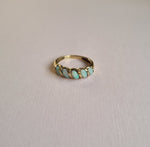 Wavy opal band ring in 9kt gold