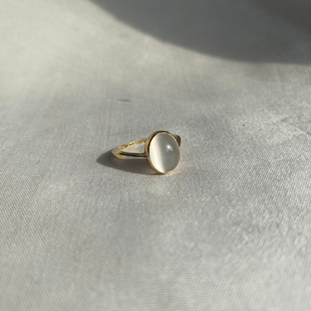 
                
                    Load image into Gallery viewer, Moonstone cabochon in 18kt gold bezel setting
                
            